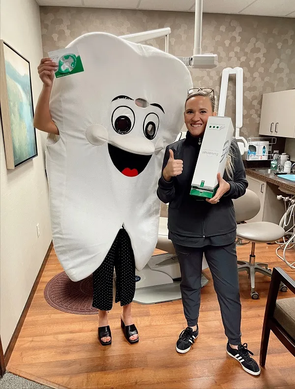 person in a giant tooth suit