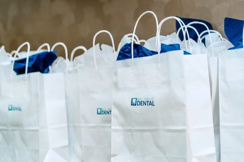 bags with bel drive dental logo on them