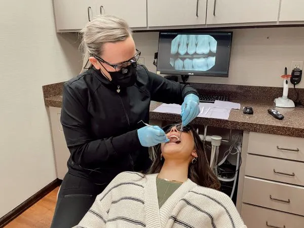Dr. Krajicek performing a dental check-up on a patient
