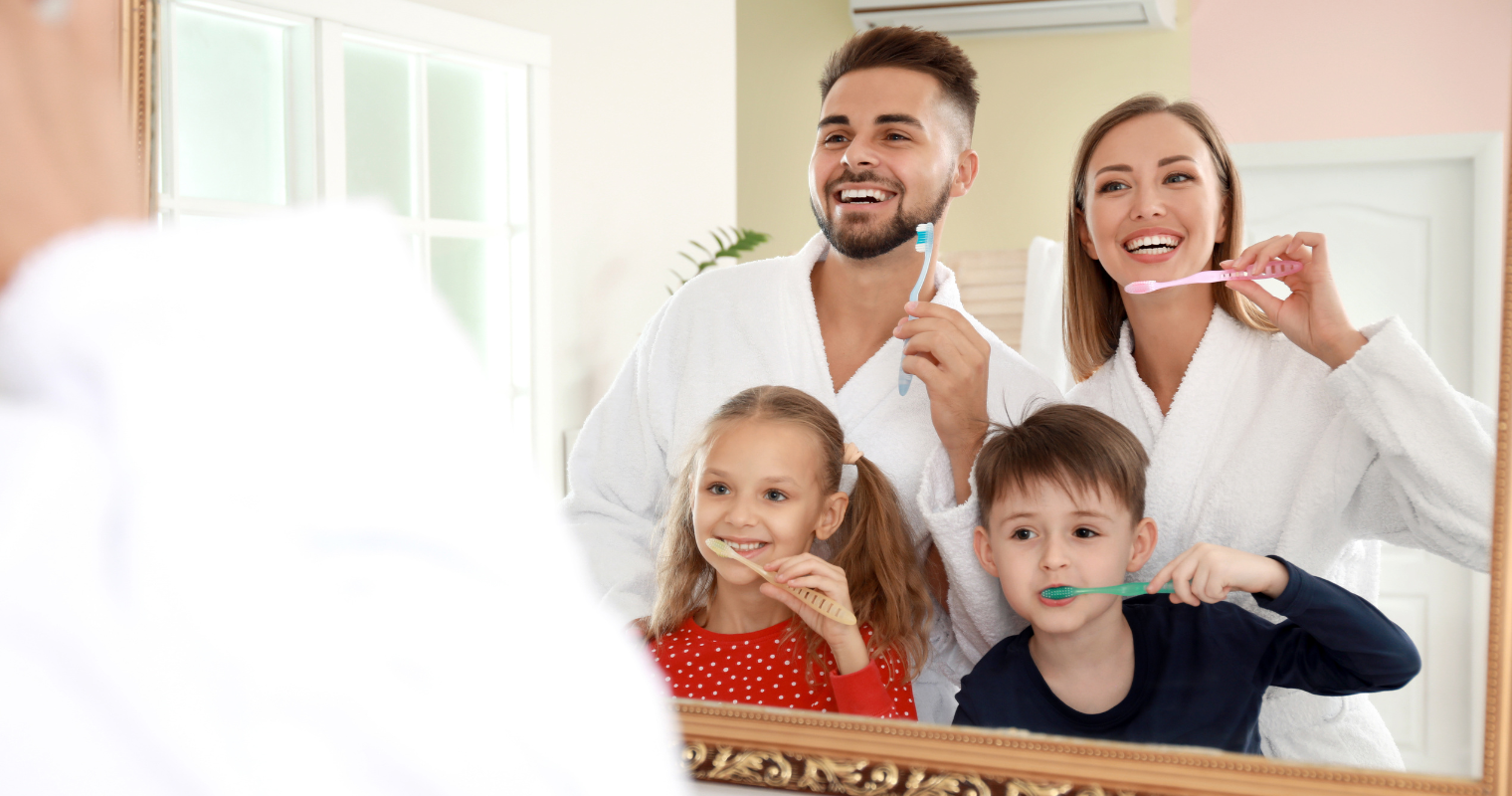 Smiling family implementing healthy oral habits in the new year 