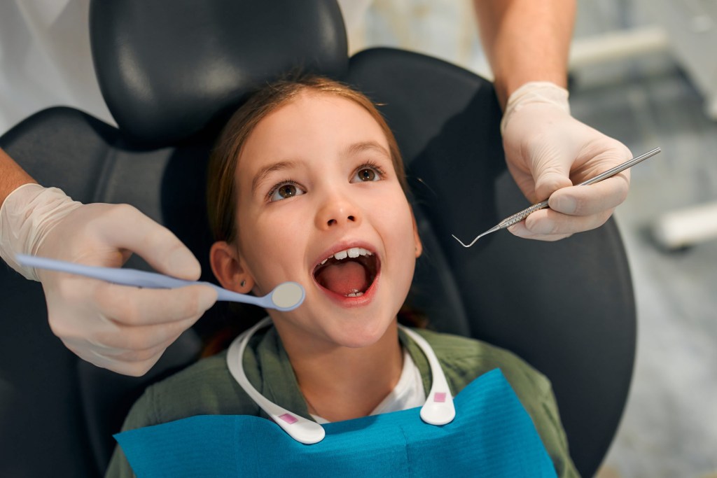 child little girl sitting in dental chair